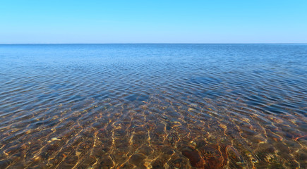 lake with calm water and a clear blue sky