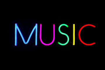 Multicolored music sign on isolated black background. Neon concept. Modern style. Neon sign. Flat lay, copy space, top view. 