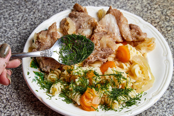 Cooking. Grilled meat on a plate with garnish and tomatoes