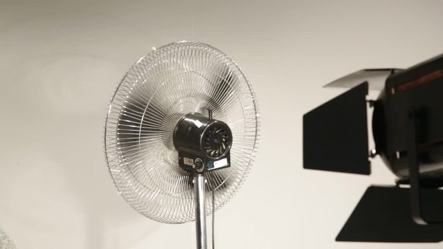fan in white wall bts