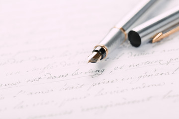 Fountain pen on an ancient handwritten letter. Old story. Retro style.