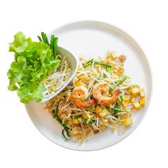 Fried noodles or Pad Thai with Fresh Shrimp, spring onions and tofu And lettuce, bean sprouts on a plate isolated white background. Top view