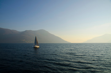 Fototapeta premium Sailing Boat on an Alpine Lake with Mountain in Switzerland.