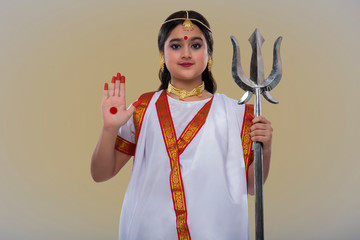child dressed up as goddess durga