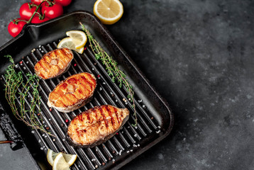 Grilled salmon steak with in a grill pan with spices