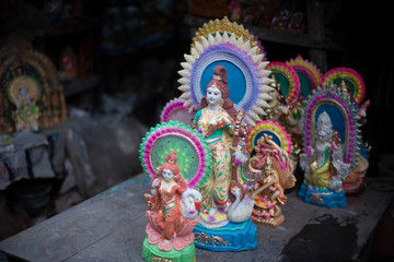 Clay idols of Hindu Goddess Saraswati being made and displayed for the Indian Bengali festival in winter in Bengal. Indian culture and religion.