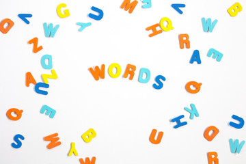 Colorful letters and letters spelled Word on white background, learning or study concept