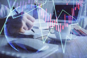 Financial chart drawn over hands taking notes background. Concept of research. Double exposure