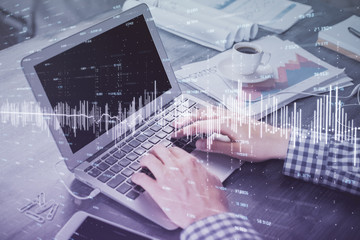 Double exposure of forex graph with man working on computer on background. Concept of market analysis.