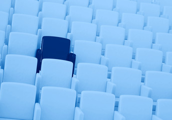 Obraz premium 3D rendering of auditorium with one reserved seat toned in trendy Classic Blue color of the Year 2020