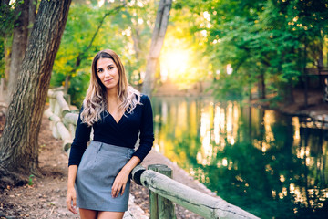 Beautiful executive business woman posing in business attire in a natural environment.