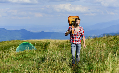 Music makes me stronger. country music song. cowboy man with acoustic guitar player. hipster fashion. happy and free. western camping and hiking. sexy man with guitar in checkered shirt
