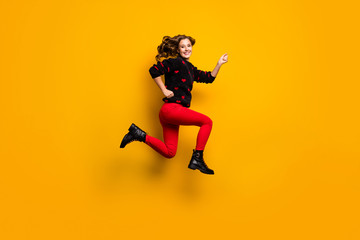 Fototapeta na wymiar Full length profile photo of funny lady jump up high speed rushing low prices addicted shopper wear hearts pattern sweater red trousers footwear isolated yellow color background