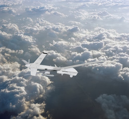 military RC military drone flies flies against backdrop of beautiful clouds on blue sky background. Elements of this image furnished by NASA