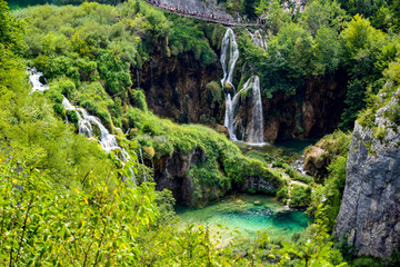 Plakat Plitvice Lakes National Park, Croatia - a UNESCO World Heritage Site. Interconnected turquoise lakes. Around the lakes are trees and rocks, which are washed by the water of the lakes.