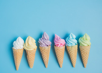 Colorful sweet ice cream cone isolated on blue pastel background ,holiday and relax concept