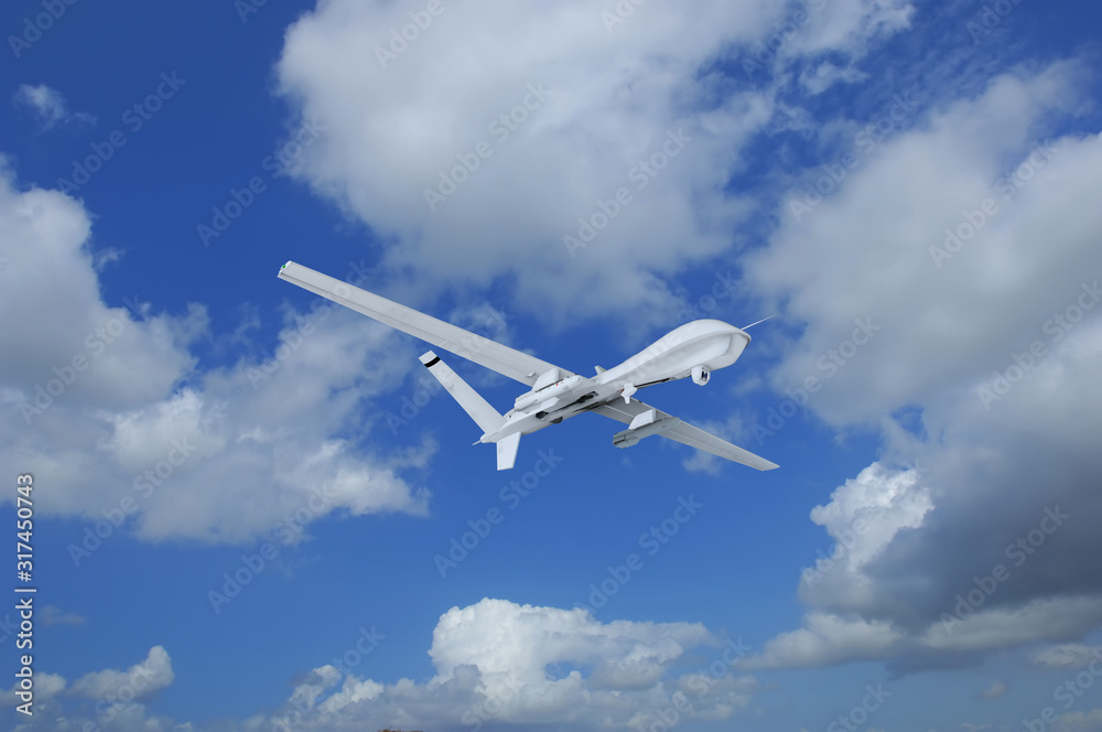 Wall mural military RC military drone flies flies against backdrop of beautiful clouds on blue sky background. Elements of this image furnished by NASA