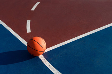 An orange ball on basketball court