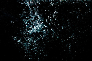 water waves with beautiful bubbles on a black background.