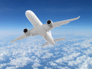 Fototapeta na wymiar large white passenger plane flies high above the clouds