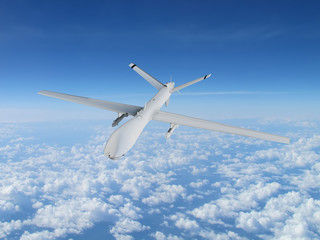 Fototapeta na wymiar military UAV airplane flies against backdrop of beautiful clouds on blue sky background