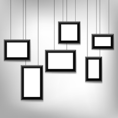 Blank picture hanging frames isolated on grey background. Modern photo frames.