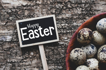 Happy easter text written on a chalk board.