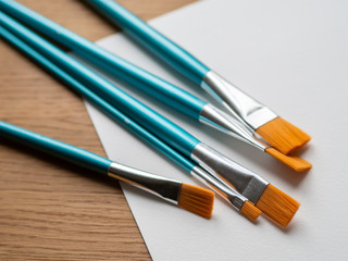 Fototapeta premium New unused painting brushes on a white paper. 