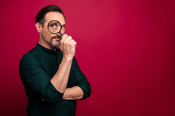 Photo of looking searching man watching you by using loupe investigating the crime isolated vivid color background