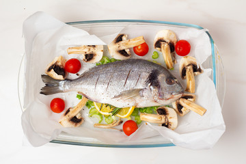 fish on a plate with lemon and salad