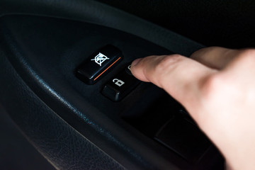 Close-up, Asian hands pressing button to lock car door inside