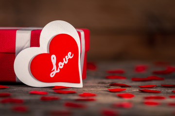 Valentine's day greeting card for love with red and white heart shape and gift box on wooden background