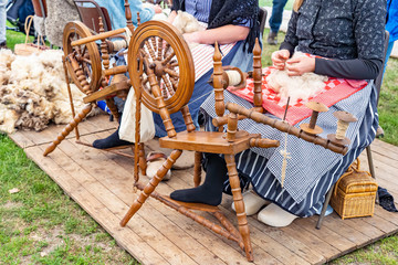 A demonstration of how to spin wool on a spinning wheel at the sheepshearingfestival in Exloo, the...