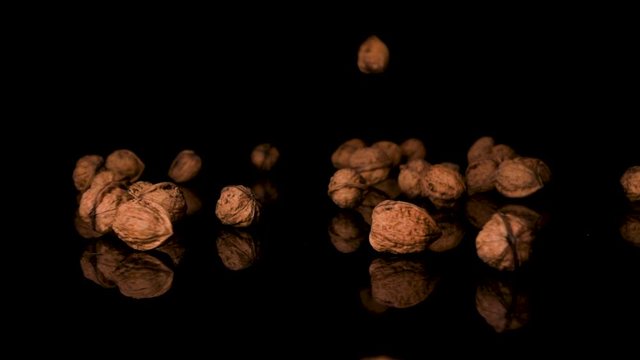 Walnuts Falling On Black Surface, English Shelled Walnuts, Close-Up