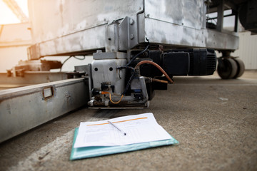 Defocused manually operation checklist paperwork pen of building maintenance unit placing on the floor clear emergency sensor unit device picture the background construction site building 
