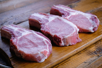 fresh raw pork loin with ribs on a wooden background