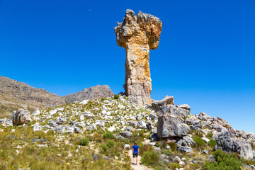 Woman looking at the rock formation Maltese Cross - a popular hiking destination in the Cederberg, South Africa