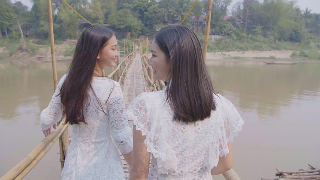 Two Asian Girls Walking On Bamboo Bridge, Slow Motion 