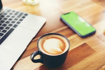 cup of coffee and notebook on table