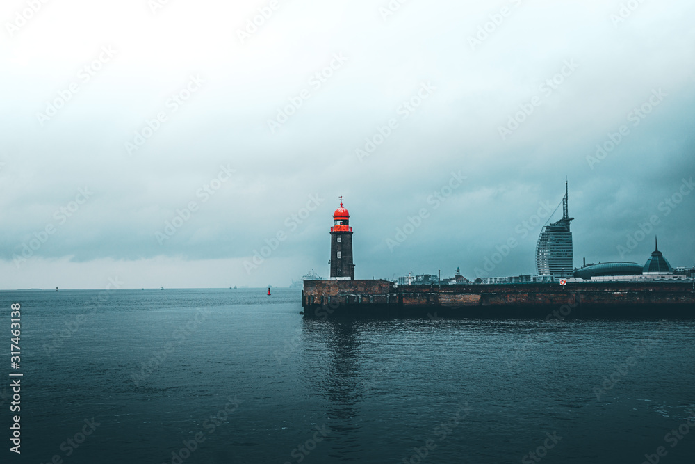 Wall mural lighthouse at a rainy day 