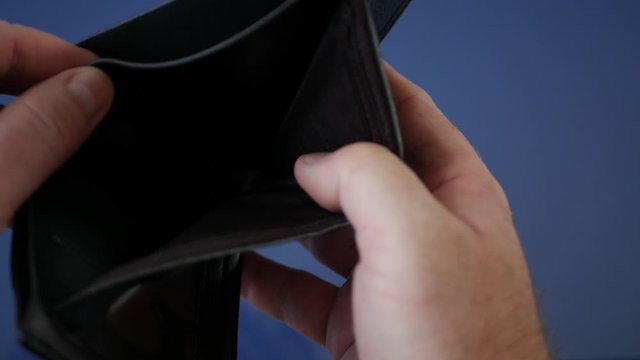 Close Up Image with Businessman Searching Cash in an Empty Wallet 
