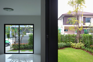 empty room with landscaping green grass turf for backyard outside a new residential house