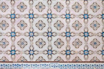 historical azulejos tiles, facade decoration portugal. beautiful floral ornament pattern, blue brown and light pink