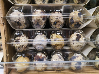 quail eggs in plastic packages are for sale on a counter in a large shopping center