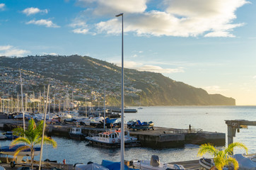 Fototapeta na wymiar View of the port of Funchal with small boats while the sun has just risen, Funchal, Madeira, Portugal on December 17, 2019