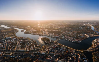 Fotobehang panorama drone photo of the old city Treptow-Kopenick Berlin at sunrise © wideeyes