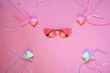 Flytlay layout on the theme of love. Pink glasses and hearts with ribbons. The concept on Valentine's Day