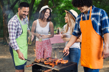 Group of happy young friends having barbecue party, outdoors
