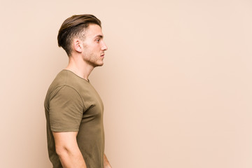 Young caucasian man posing isolated gazing left, sideways pose.