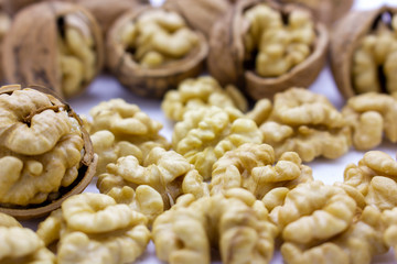 Peeled nuts. Walnuts, kernels and shells on a white background.